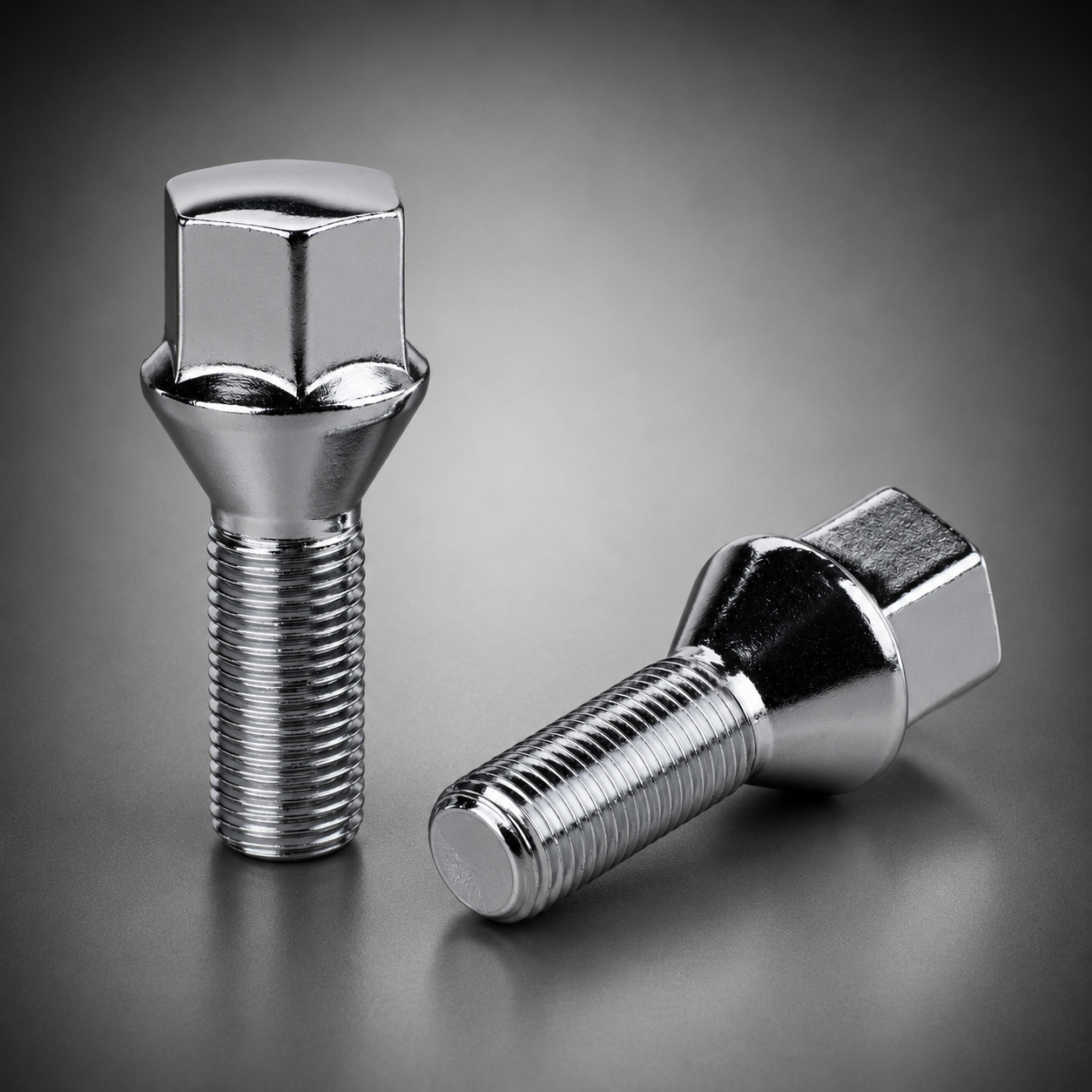 Two polished chrome hex socket bolts on a dark gray gradient background, one standing upright and the other lying on its side.