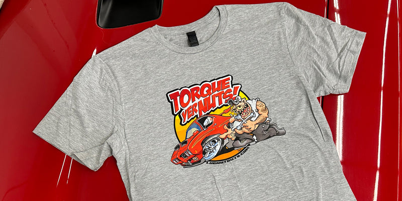 A heather gray t-shirt featuring the Lug Nut Guys artwork "Torque Yer Nuts" laying on the hood of a Red 1970 GTO Judge